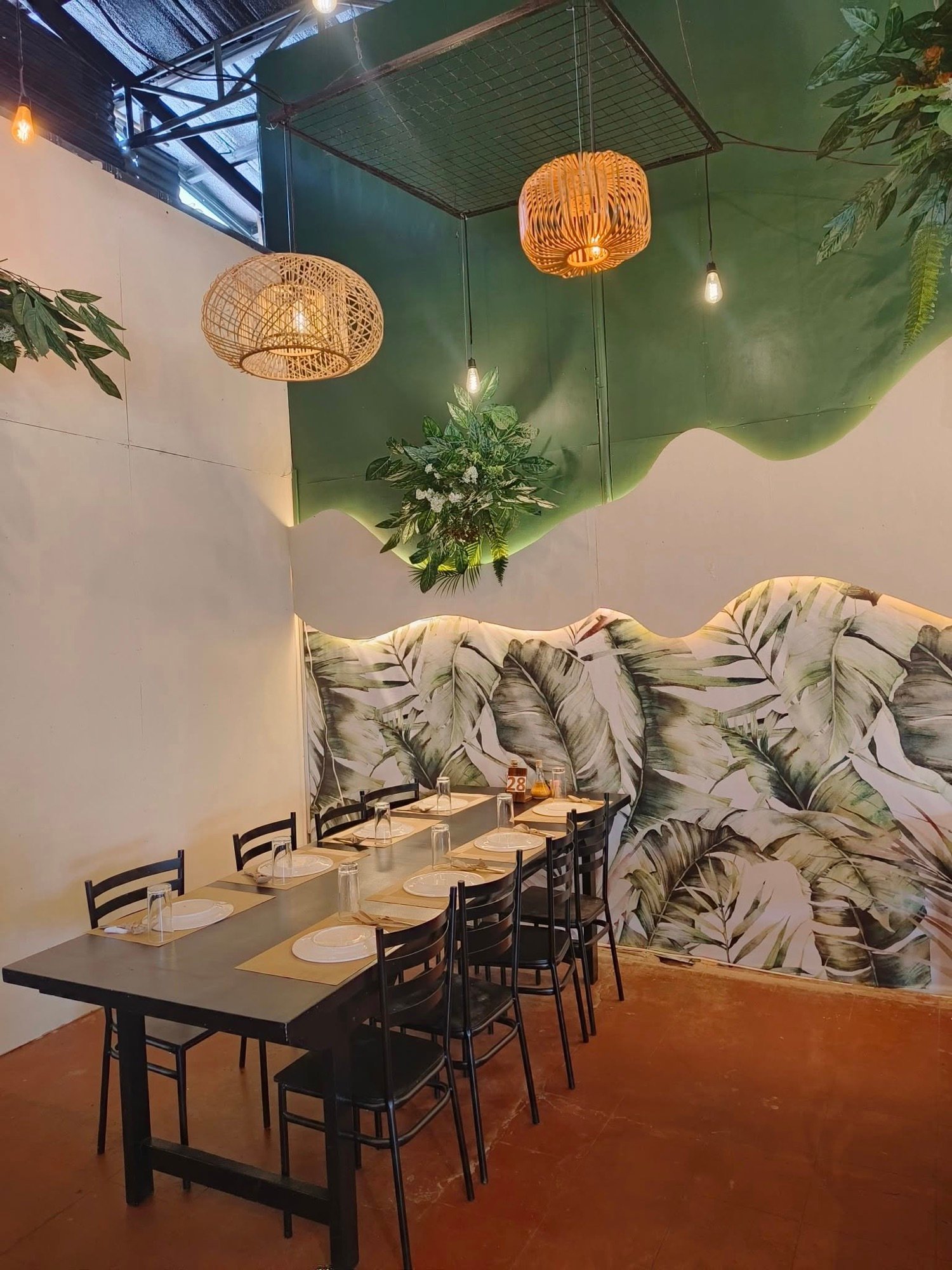 Booth seating under tropical-print walls